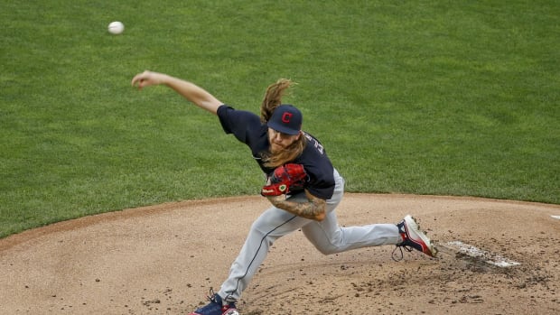Jul 31, 2020; Minneapolis, Minnesota, USA; Cleveland Indians starting pitcher Mike Clevinger (52) throws to the Minnesota Twins in the first inning at Target Field. Mandatory Credit: Bruce Kluckhohn-USA TODAY Sports